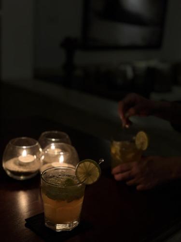 a table with three drinks with candles and a lemon slice at Nyne Hotels Mayur Lodge - Yala - All Inclusive in Yala