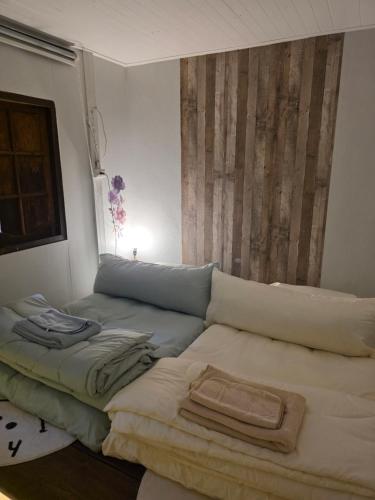 a living room with a couch and a bed at THE REAL ESCAPE - Koh Yao Noi in Ko Yao Noi