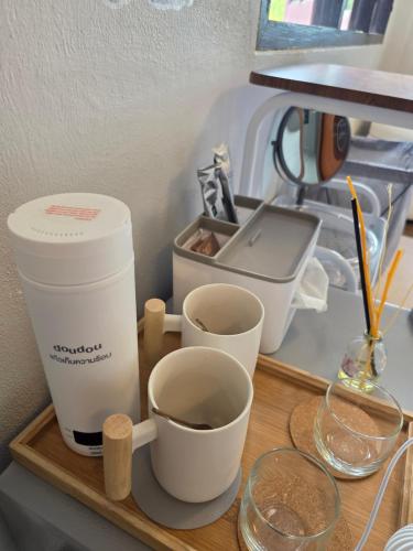 a wooden tray with cups and a coffee maker at THE REAL ESCAPE - Koh Yao Noi in Ko Yao Noi