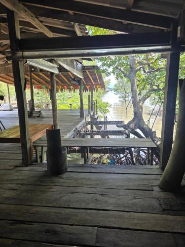 a group of picnic tables on a wooden deck at THE REAL ESCAPE - Koh Yao Noi in Ko Yao Noi