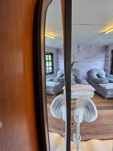 a mirror with a reflection of a room with beds at THE REAL ESCAPE - Koh Yao Noi in Ko Yao Noi