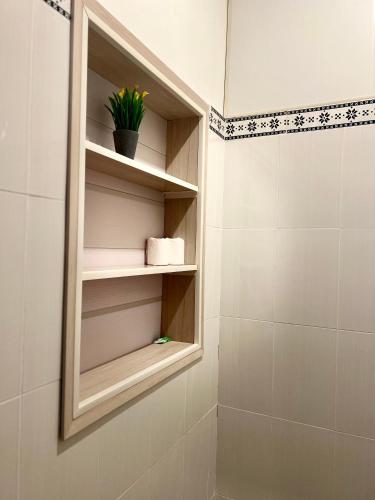 a bathroom with a mirror and a shower at Varmana Ubud - The Blue House in Ubud