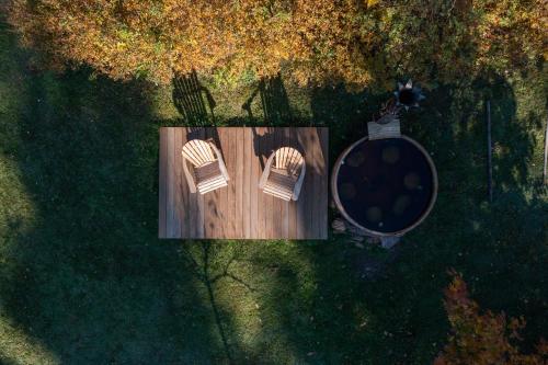 an overhead view of two chairs on a wooden deck at Chalet avec bain nordique et sauna in Dabo