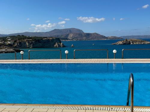 a swimming pool with a view of the ocean at Apartment Sunkiss in Almirida