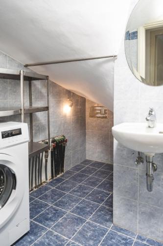 a bathroom with a sink and a washing machine at Alkara Square in Naxos Chora