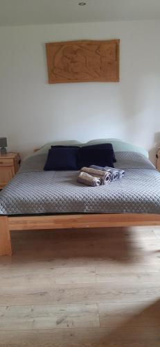 a bed with a wooden frame in a bedroom at Domek pod Skiełkiem in Łukowica