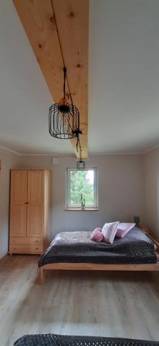 a bedroom with a large bed in a room at Domek pod Skiełkiem in Łukowica