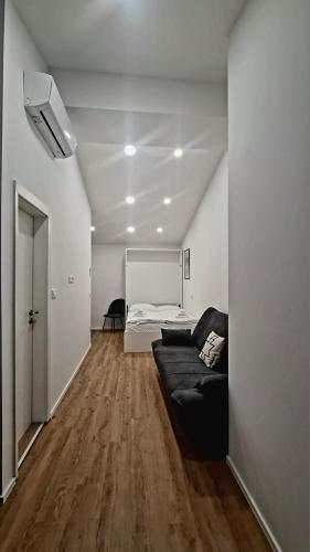 a living room with a couch and a bed at Hotel Maslina in Seget