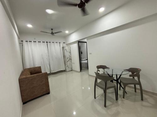 a dining room with a table and a chair at Atithi Homes Luxe Kandivali Suites in Mumbai