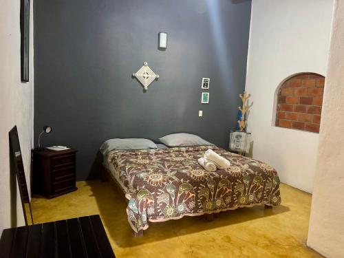 a bedroom with a bed with a bedspread on it at Refugio del Cielo # in Sayulita