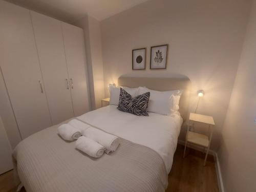 a bedroom with a white bed with towels on it at 210 The Meadows in George