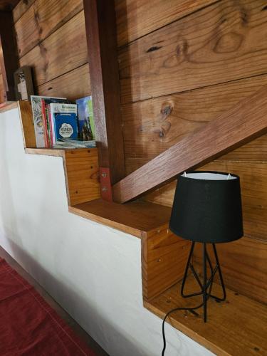 a lamp sitting on top of a wooden wall at Ti Palissandre in LʼEntre-Deux