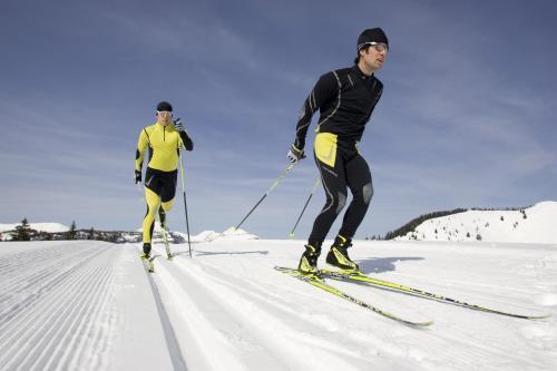 two men are cross country skiing in the snow at Hotel Zehnerkar & Hotel Obertauern in Obertauern