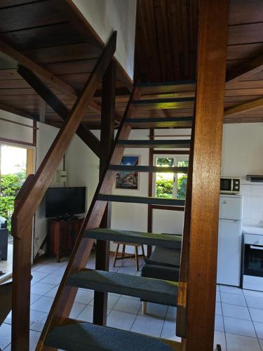a spiral staircase in a room with a kitchen at Ti Palissandre in LʼEntre-Deux