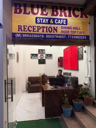 a man sitting at a desk in a office with a laptop at Blue Brick in Jodhpur