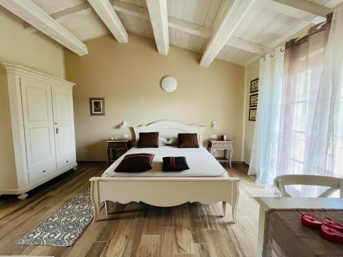 a bedroom with a large white bed in a room at Agriturismo Il Molino in Quercianella