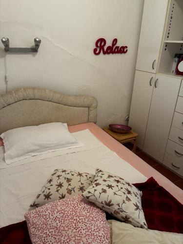 a bedroom with a bed with a white bedspread at Apartment Simo in Herceg-Novi