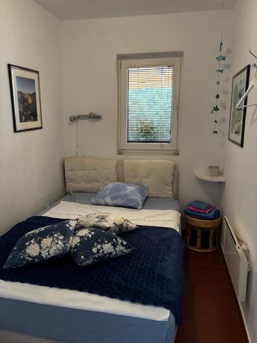 a bed in a room with two pillows on it at Apartment Simo in Herceg-Novi