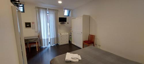 a bedroom with a bed and a dresser and a cabinet at Ecoflat Casa Vacanze in Lipari