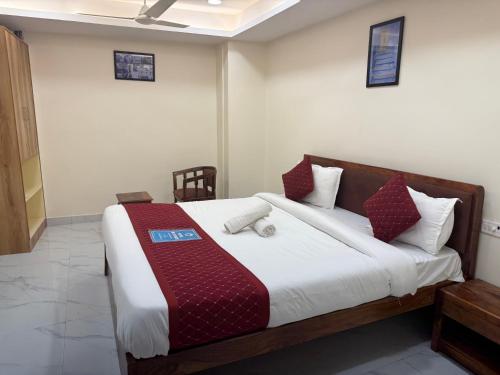 a bedroom with a large bed with red and white pillows at Blue Brick in Jodhpur