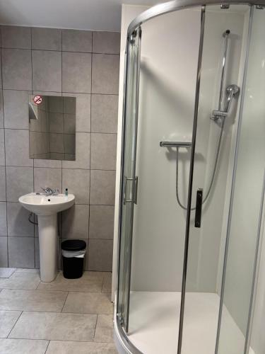 a bathroom with a shower and a sink at The Tudor House Hotel in Nottingham