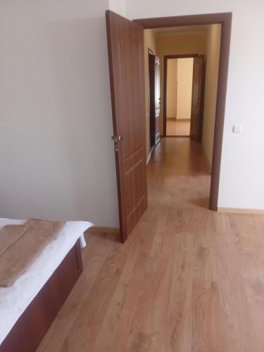 an empty room with a bed and a hallway at DOBA - Центр - Бограч 2 кім 6 міс Завжди тепла ! in Mukacheve