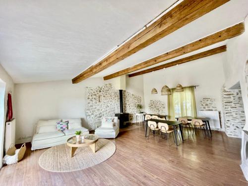a living room with a couch and a table at Suites zen dans maison d'hôtes avec piscine intérieure et jardin in Ventenac-Cabardès