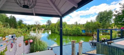 a view of a river from a house with a deck at Lily Lake Lodge in Chelmsford