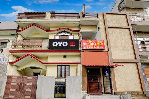 an apartment building with an ovo sign on it at HOTEL O VIP HILL HOMESTAY in Mājra