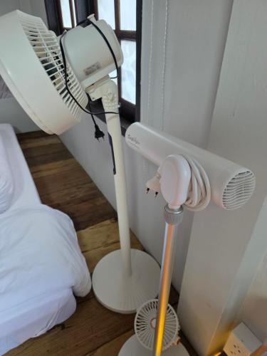 a room with a blow dryer and a fan next to a bed at THE REAL ESCAPE - Koh Yao Noi in Ko Yao Noi