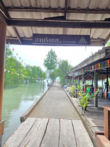 a bridge over a river with a sign on it at THE REAL ESCAPE - Koh Yao Noi in Ko Yao Noi