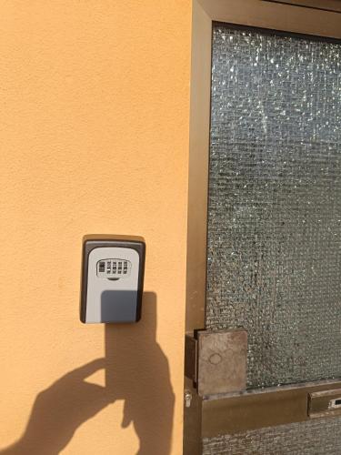 a clock on the side of a door with its shadow at Wohnung auf dem Bezenberg in Kaiserslautern
