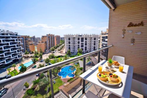 a balcony with a plate of food on a table at APARTAMENTO ARENA en Playa de San Juan in Alicante