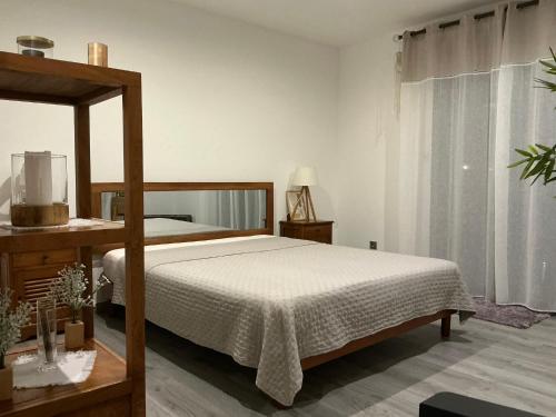 a bedroom with a bed and a large window at L'étoile du Pic in Sainte-Clotilde