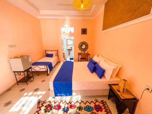 a bedroom with two beds in a room at FERME D'HOTES BARGHALi in Marrakech