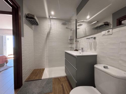 a bathroom with a toilet and a sink at The Piano House in Rincón de la Victoria