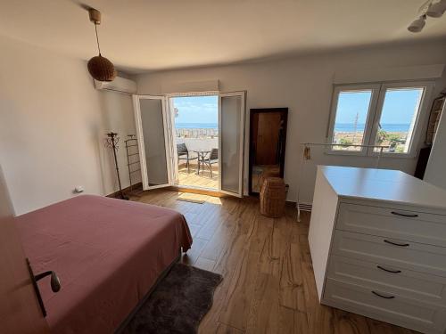 a bedroom with a bed and a desk with a view at The Piano House in Rincón de la Victoria