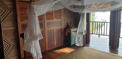 a room with a curtain hanging over a door at Lodge Villa MAYANKI in Dzamandzar