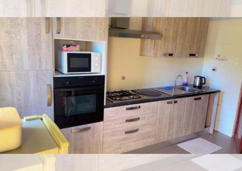 a kitchen with a stove and a microwave at Chez Ouly in Dakar
