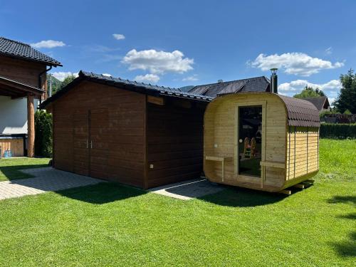 a large wooden shed sitting on the grass at Luxapart Golf Ostravice in Ostravice