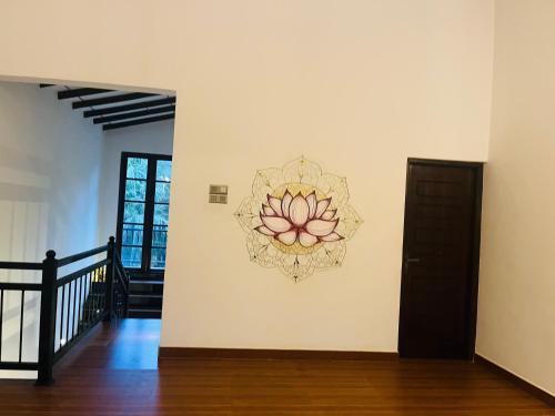 a painting of a flower on a wall at Mashi's Villa in Sigiriya