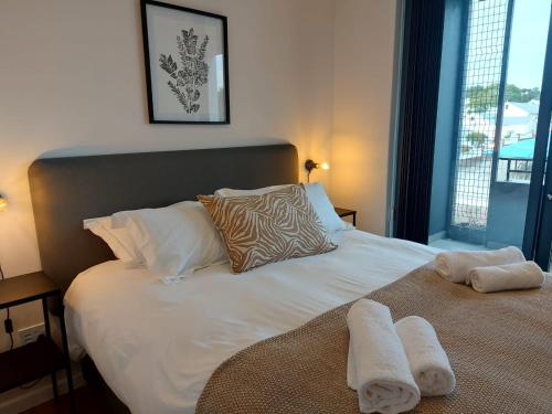 a bedroom with a bed with towels on it at 309 The Meadows in George