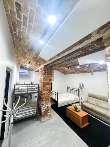 a living room with a couch and a bed and a table at Wagner's Refuge 1 in Riga