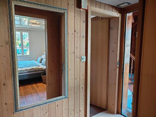 a mirror on the wall of a room with a bedroom at Interlaken house with Harder Kulm view in Matten
