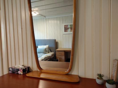 a mirror sitting on top of a wooden table at Interlaken house with Harder Kulm view in Matten
