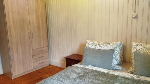 a bedroom with a bed and a cabinet at Interlaken house with Harder Kulm view in Matten
