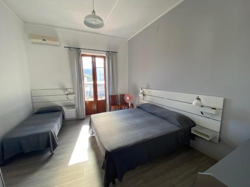 a bedroom with two beds and a window at Ecoflat Casa Vacanze in Lipari