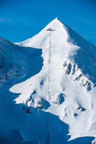 a snow covered mountain with a ski lift on it at Hotel Zehnerkar & Hotel Obertauern in Obertauern