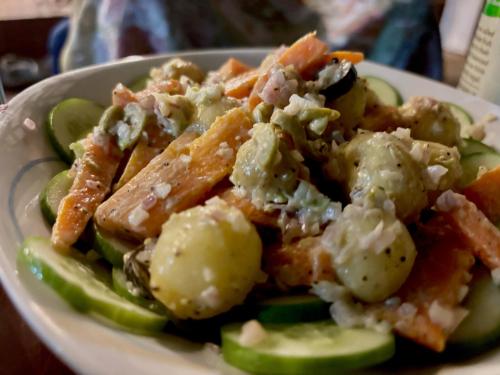 a plate of food with pasta and vegetables on a table at Sea Breeze Stay in Negombo