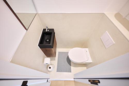 a small bathroom with a toilet and a sink at Apartment Wiels 3 in Brussels